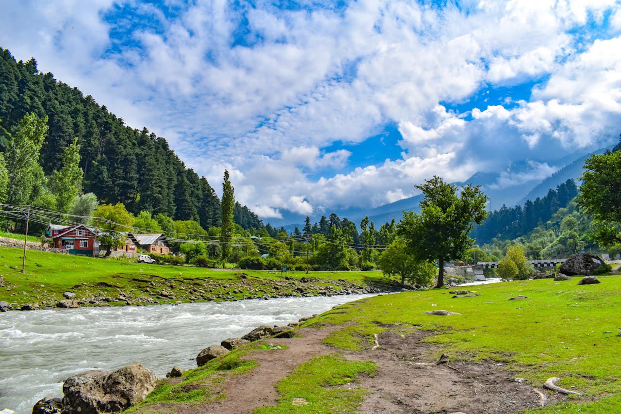 Beautiful river scene in Indonesia with lush greenery and a vibrant blue sky.